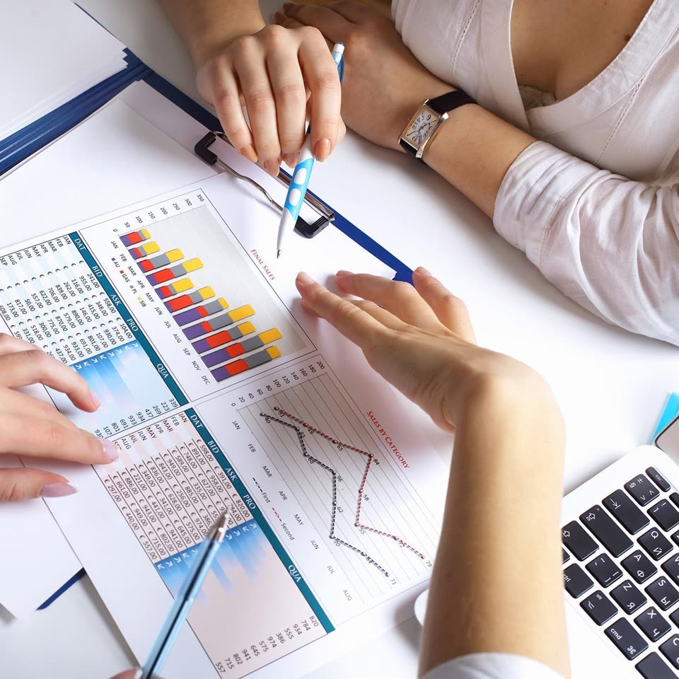 Financial charts being reviewed at a desk